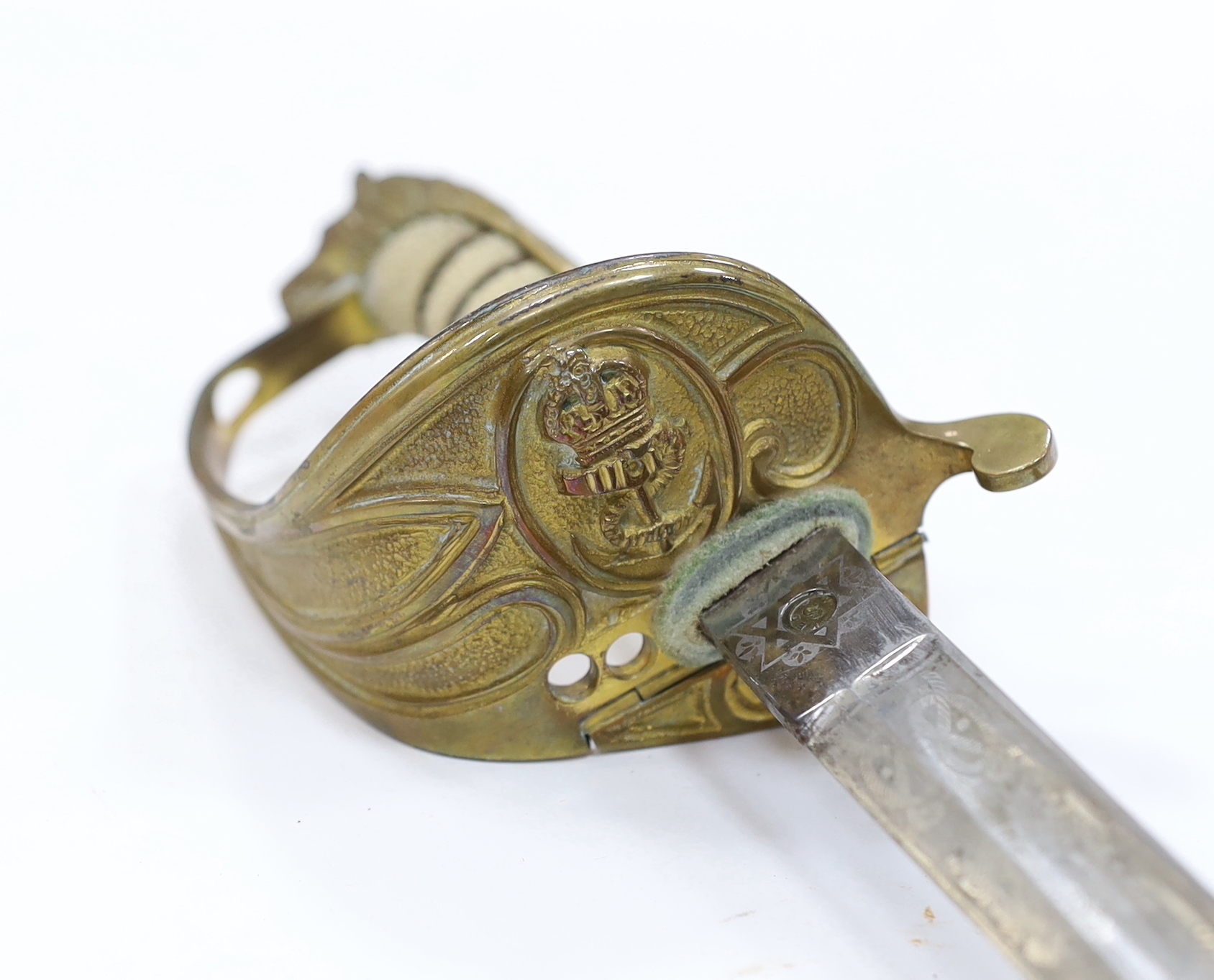 A George V naval officer’s sword, maker Grieves, in a leather scabbard, guard engraved G.P. Bewley, blade 79.5cm, together with outer leather cover